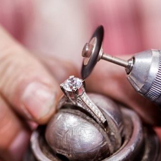 Jeweler polishing the diamond ring.